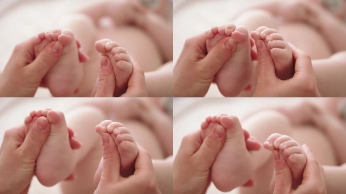 妈妈在玩婴孩的脚幼儿发展概念的伸展和练习