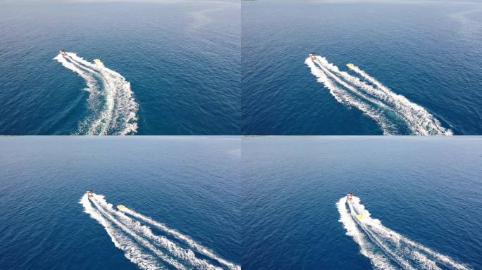从空中俯瞰拖曳管子的汽艇.希腊克里特岛·埃隆达