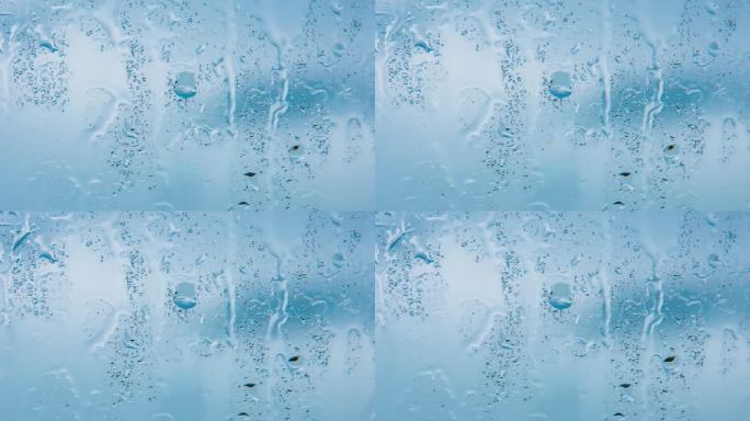 水滴的蓝色玻璃背景上的雨