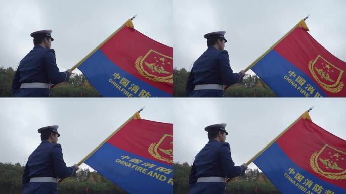 消防员手拿中国消防旗帜