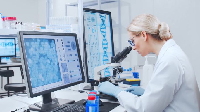 一个由专业科学家组成的小组正在一个现代科学研究实验室里研究一种疫苗。基因工程工作场所。未来的技术和科