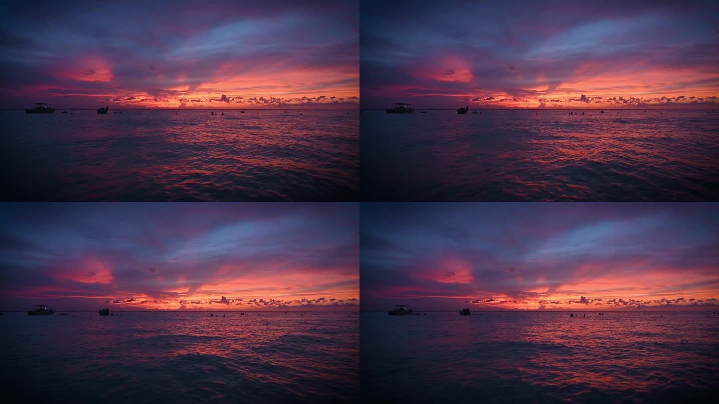 美丽的落日笼罩着五彩斑斓的大海.墨西哥妇女岛的落日照片是在水里和船上拍的