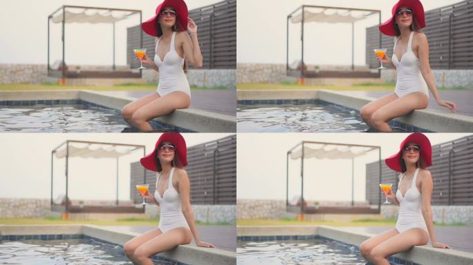 亚洲美女在酒店游泳池放松的镜头