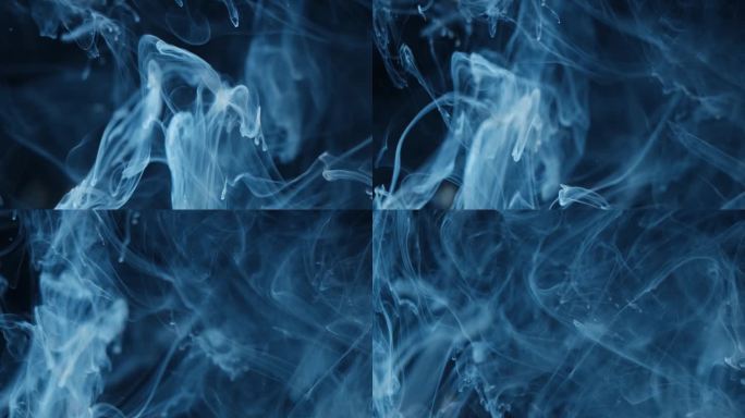 烟的抽象。云彩蓝光下的黑色背景。烟熏效果.