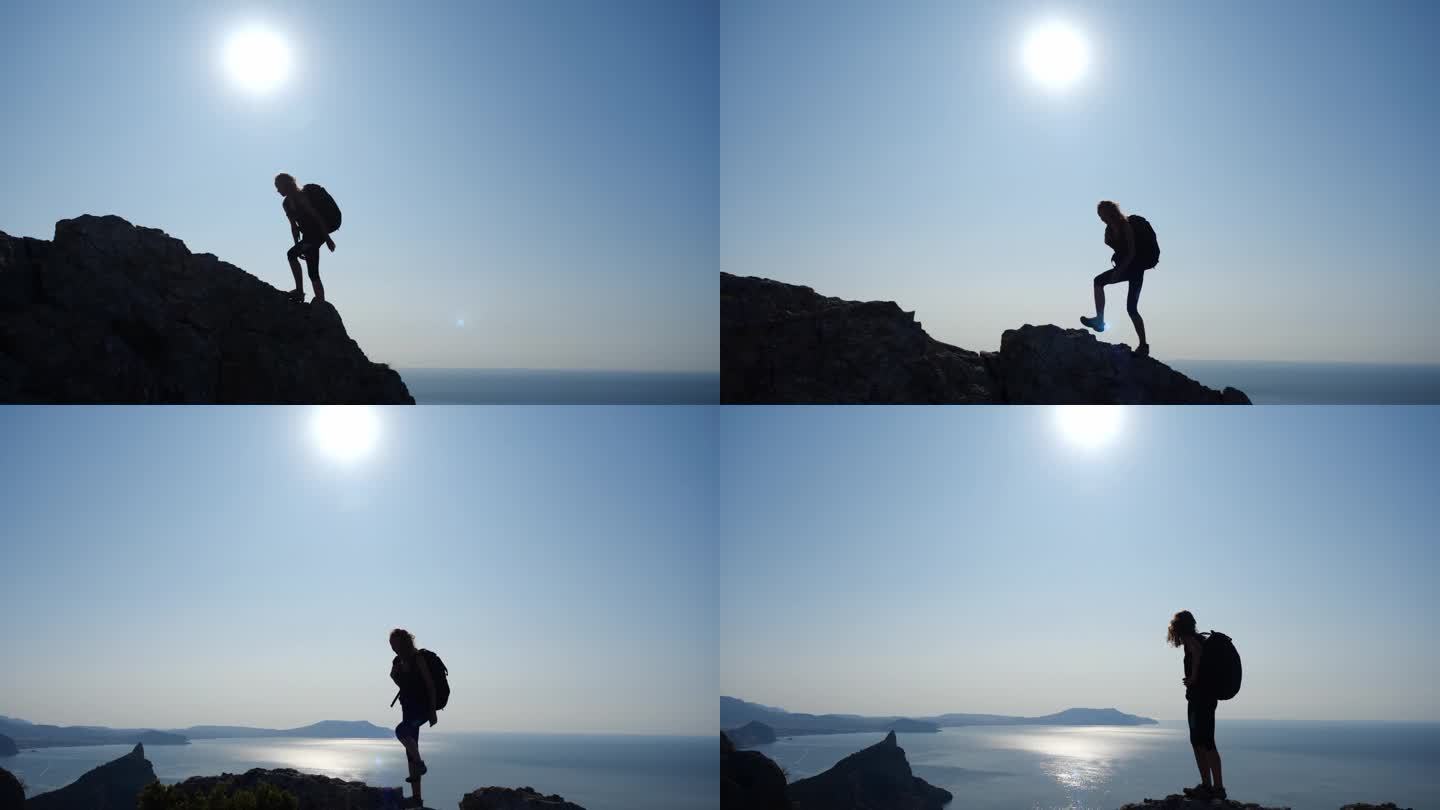身材矮小的女人背着背包爬上高高的悬崖顶上，带着太阳和夕阳西下的阳光，缓缓地从侧面看去，美丽的景色尽收