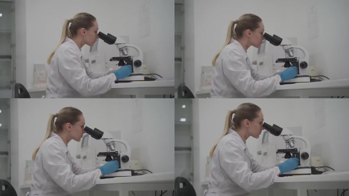女科学家在实验室工作时使用显微镜。现代医学研究实验室。女性实验室助理在显微镜下观察样本生化物质、血液