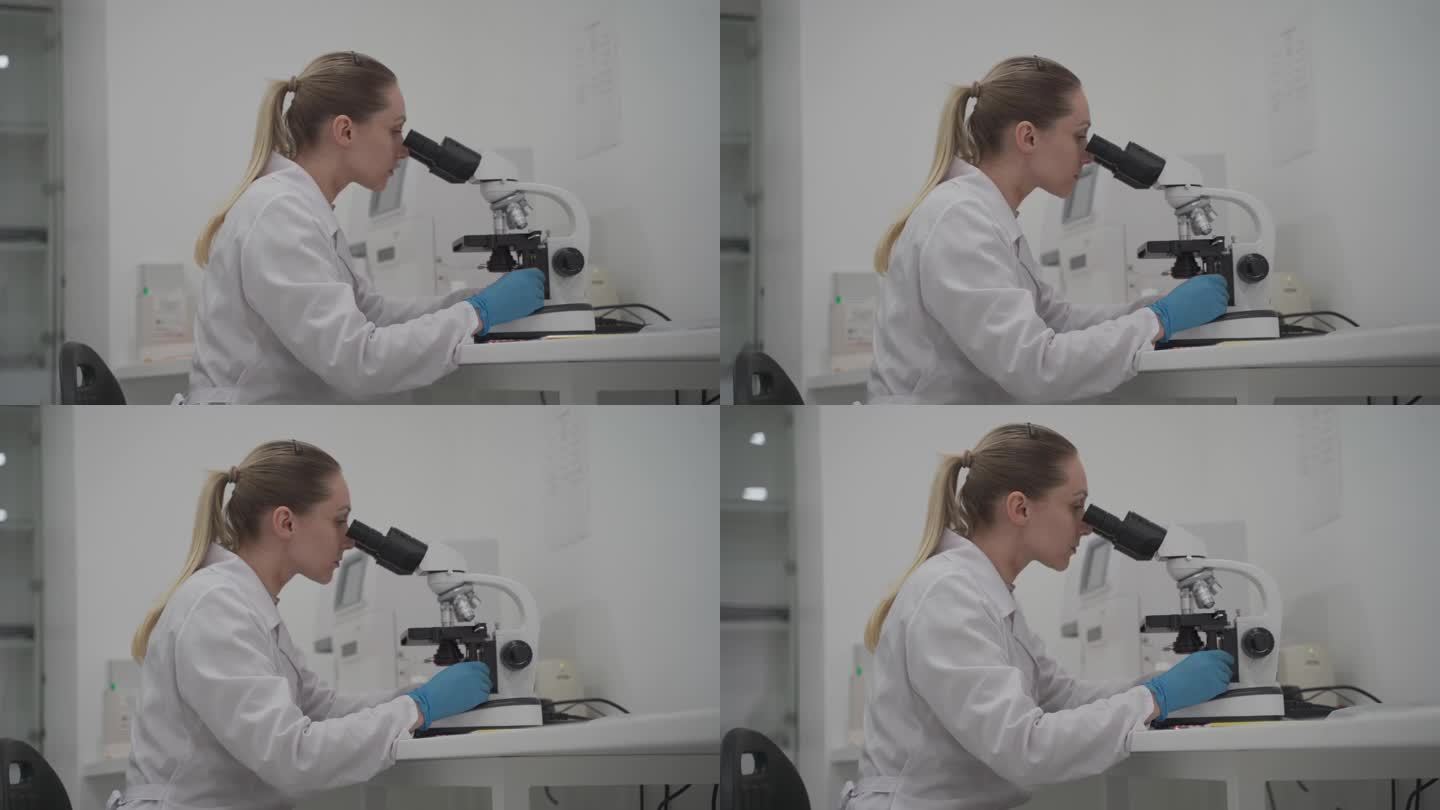 女科学家在实验室工作时使用显微镜。现代医学研究实验室。女性实验室助理在显微镜下观察样本生化物质、血液