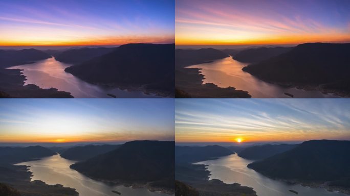 多彩的天空映衬着高山,日出时分多雾