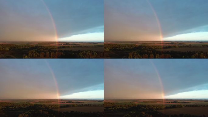 双彩虹覆盖森林和麦田。深雷雨乌云，彩虹覆盖乡郊公路景观。Areal Dron射击