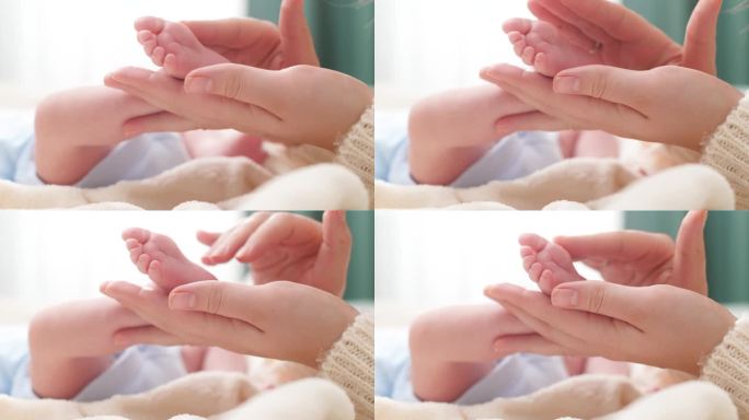 母亲触摸和抚摸新生婴儿小脚的特写镜头。家庭幸福和有年幼子女的慈爱父母的概念。婴儿按摩和保健