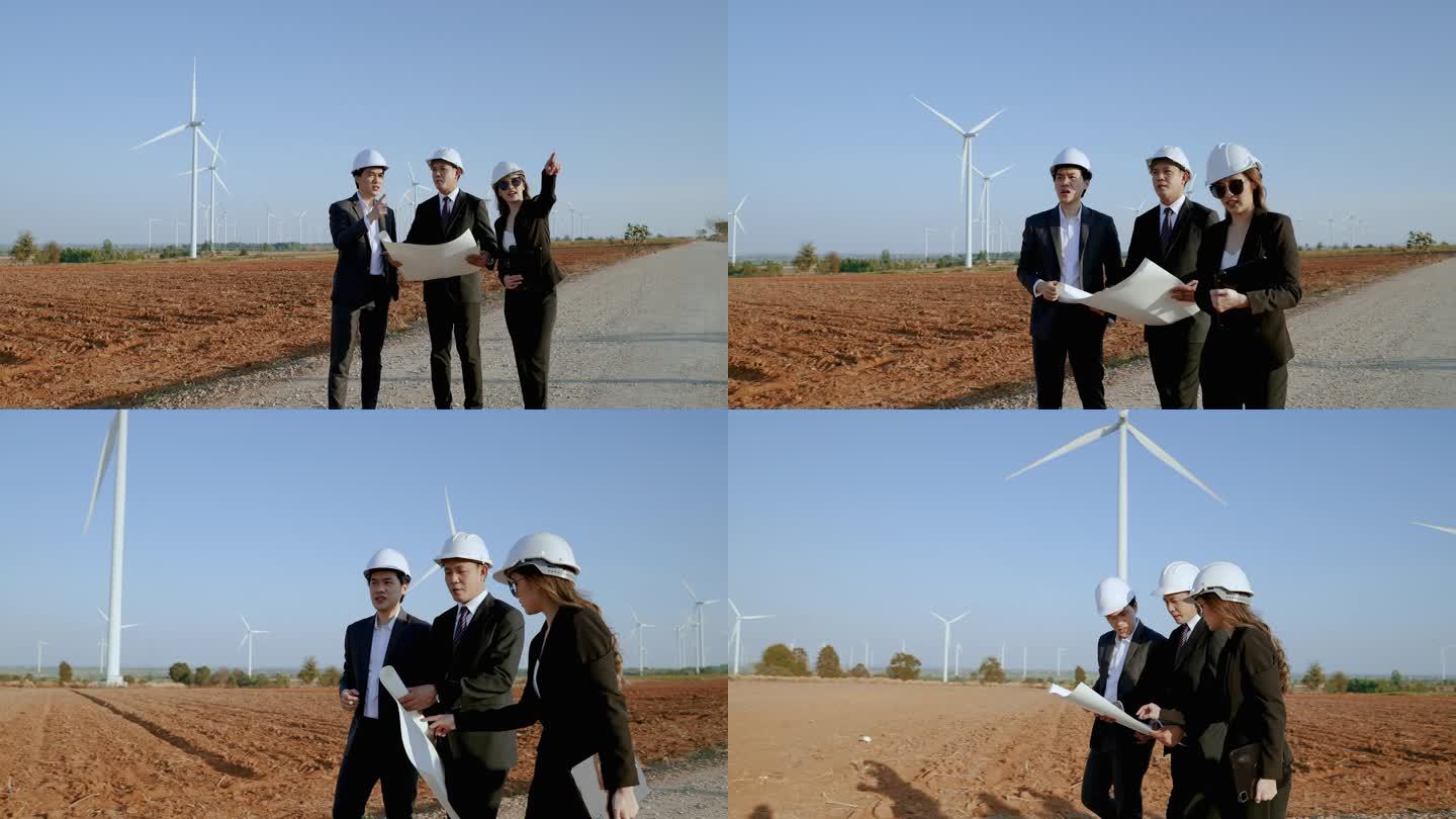 检查员和一个有秘书的工程师正在视察一个风力涡轮机发电场的一个项目。清洁能源概念、可再生能源、拯救世界