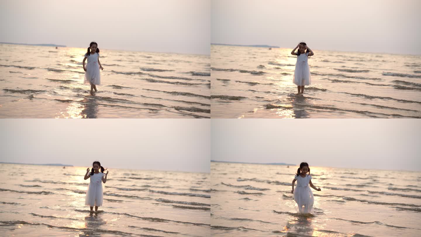 小女孩在日落时在海边