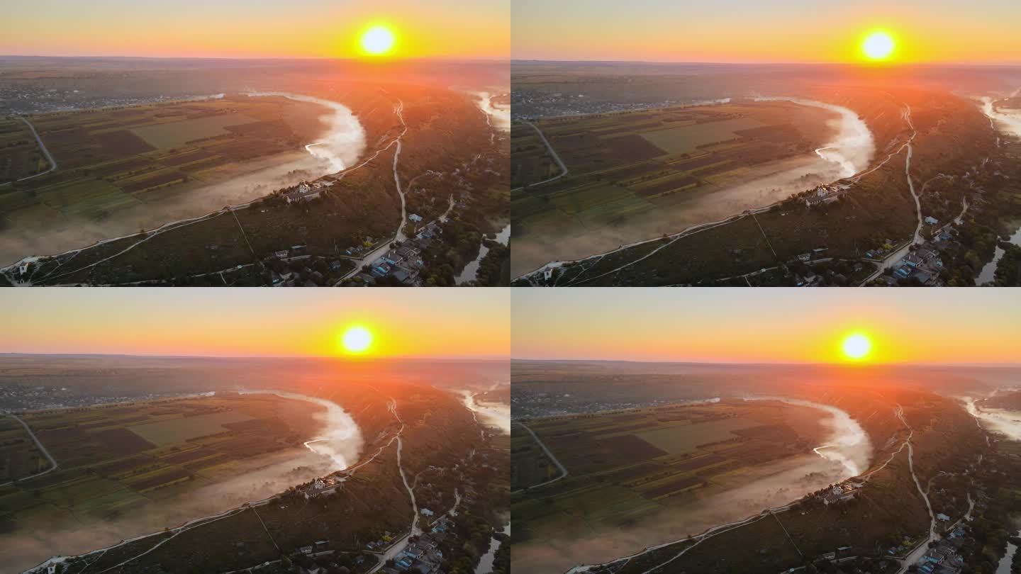 日落时从空中俯瞰老奥赫人.位于摩尔多瓦一座山上的有河流和雾的山谷、村庄、修道院