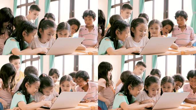 快乐的孩子们看着笔记本电脑，在课堂上讨论