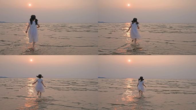 小女孩在日落时在海边