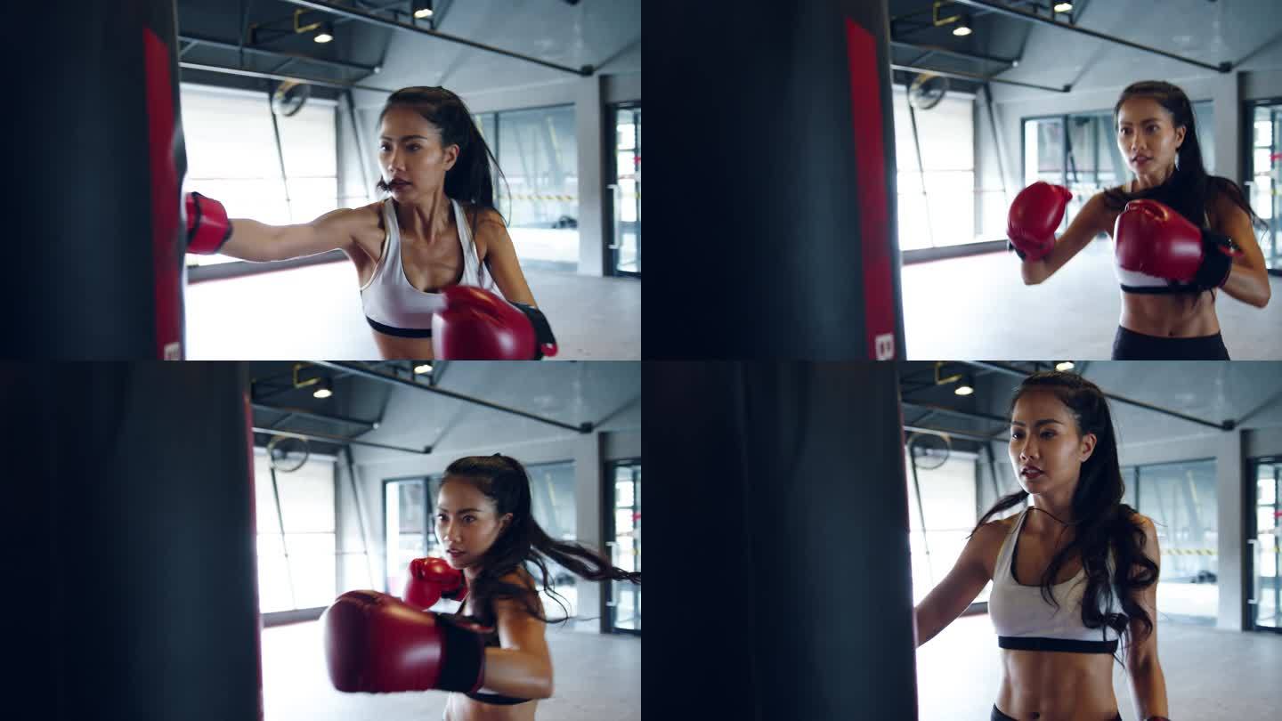 在健身课上，年轻的亚洲女子跆拳道练练习袋，强壮的女战士练拳击。女运动员娱乐活动、功能性培训、健康生活