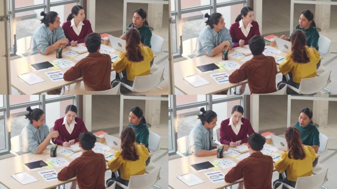多种族的年轻创意人士在智能休闲装中讨论了现代办公室的商业头脑风暴会议理念、移动应用软件设计项目。同事