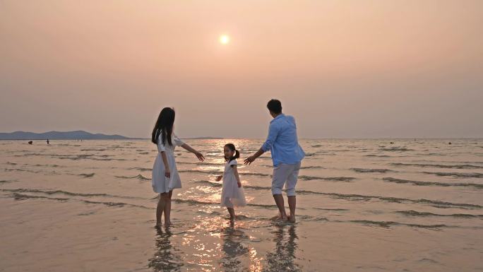 在海边玩耍的一家人  一家人海边散步
