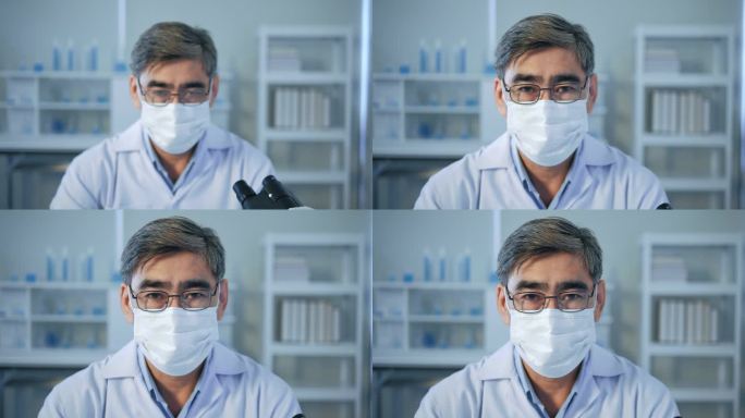 在医学实验室里戴着无菌面具看着相机的亚洲高级医生的画像。研究人员概念。近视;近视。