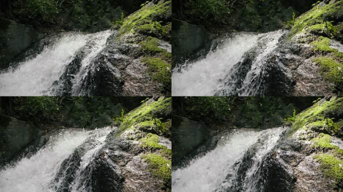 热带河流中的河流或湖泊瀑布运动缓慢，自然优美。野生山川清澈清澈的溪流.被石碑流淌的吱吱嘎吱的小溪射中