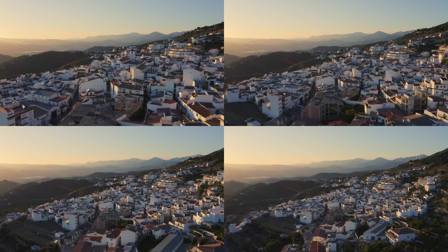 西班牙的空中无人机视图，日落时山区的西班牙小镇，太阳海岸，安达卢西亚 (安达卢西亚)，欧洲，传统的白