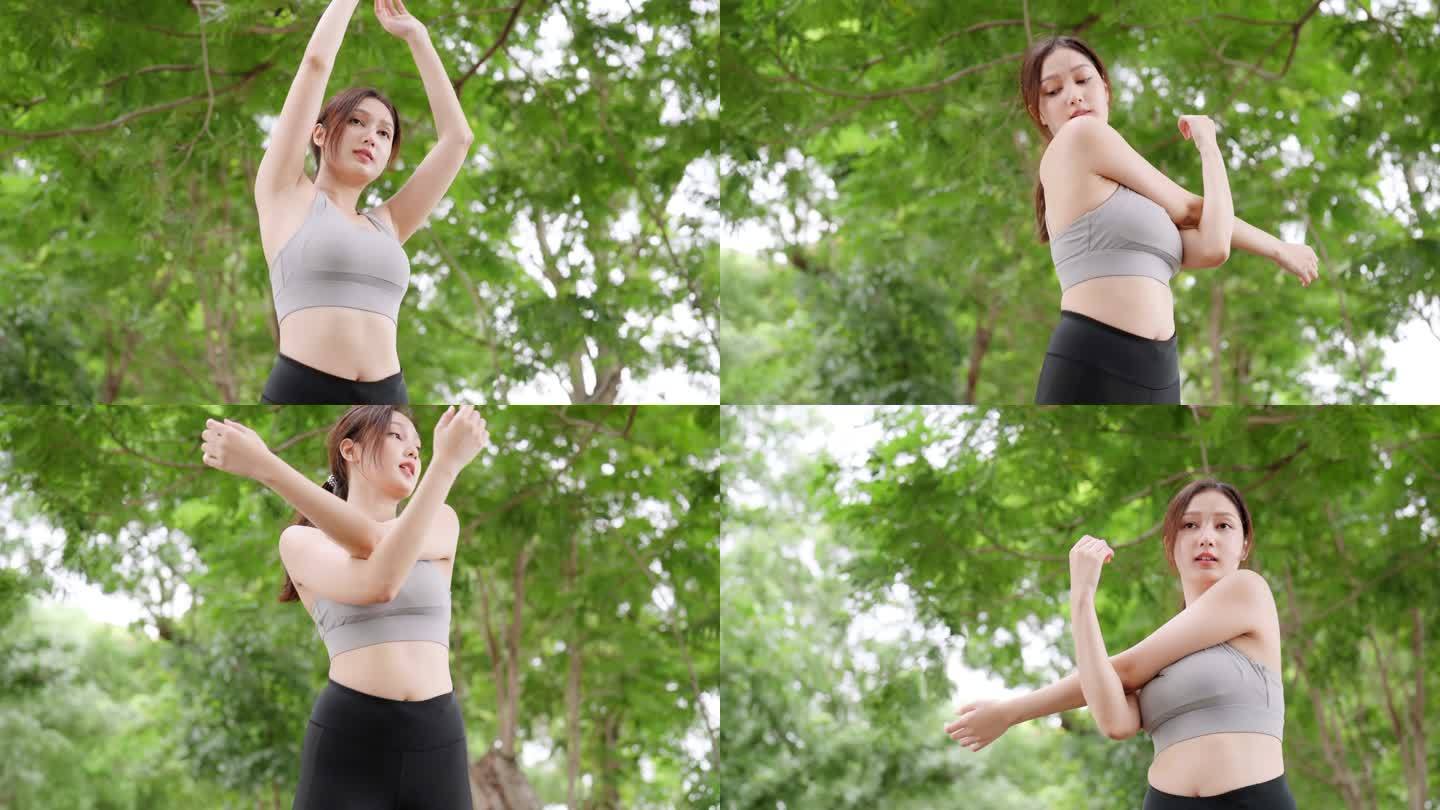 亚洲女教练在公共公园从事健身。运动的女人在户外锻炼。她伸展身体、手臂和肩膀。健康生活理念，公园户外运