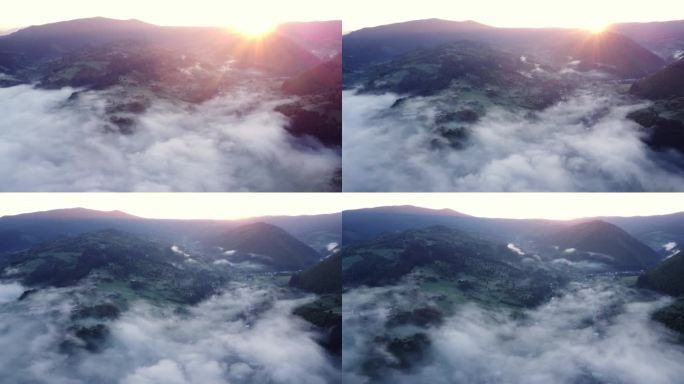 日出时，喀尔巴阡山脉中一个乡村山谷中的雾和反转云的美丽空中无人机视图。明亮的太阳从山后升起。FHD无