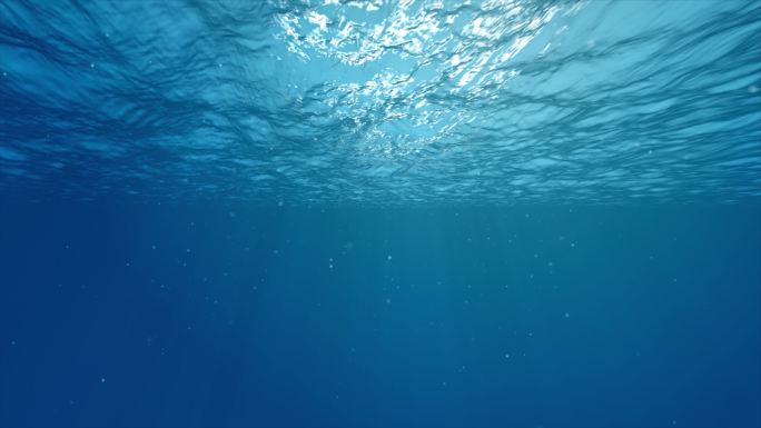 水下光影水下光线穿过深蓝色的海浪