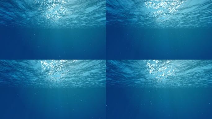 水下光影水下光线穿过深蓝色的海浪