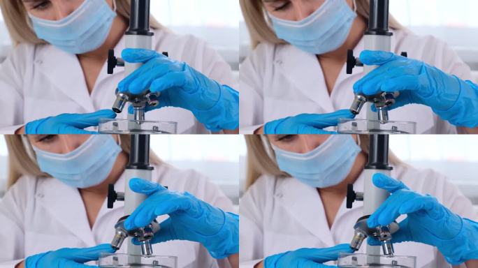 女科学家实验室助理在显微镜下观察一个带有转基因化学品样品的培养皿。微生物学家在拥有技术设备的现代实验