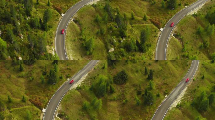 红色汽车在弯曲的道路上行驶，蜿蜒在高地的针叶林山坡上。风景秀丽的林山中的蛇形高速公路鸟瞰图