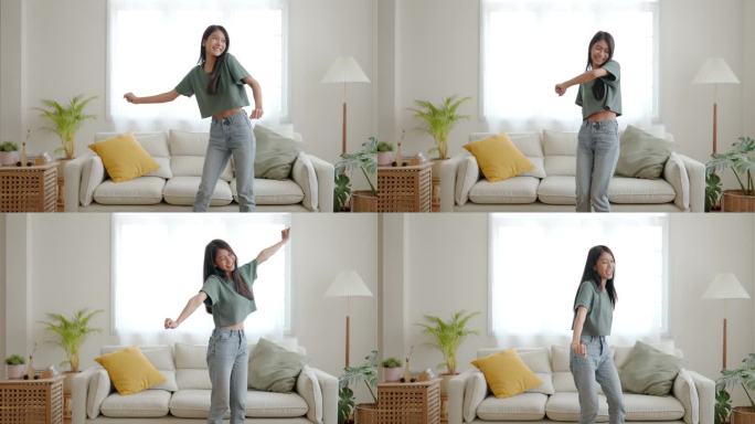 年轻的亚洲女人在家里客厅的地板上跳舞。快乐的亚洲女人笑着在家里放松，健康的精神健康和幸福