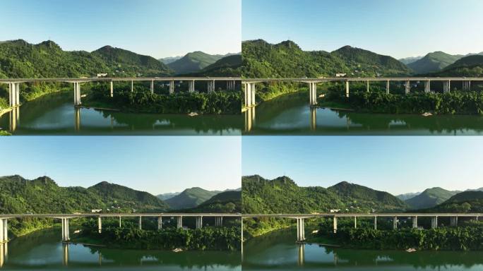 阳光下峡谷中横跨河流的高速公路大桥
