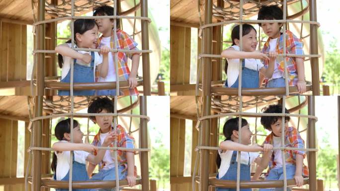 两个小孩子玩攀爬架开心交流