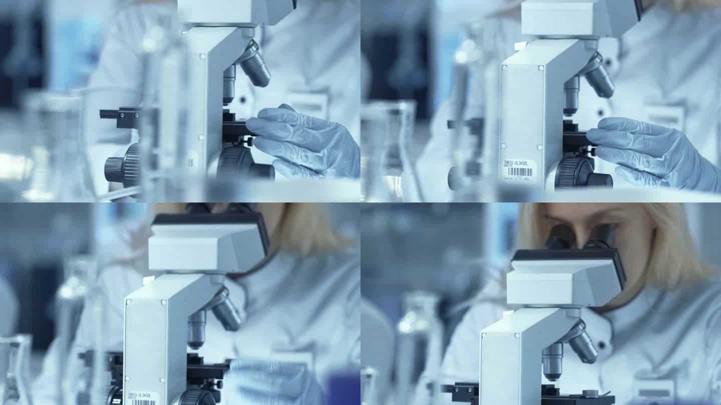 医学研究科学家看滑与显微镜下的样品。她是一家专业.