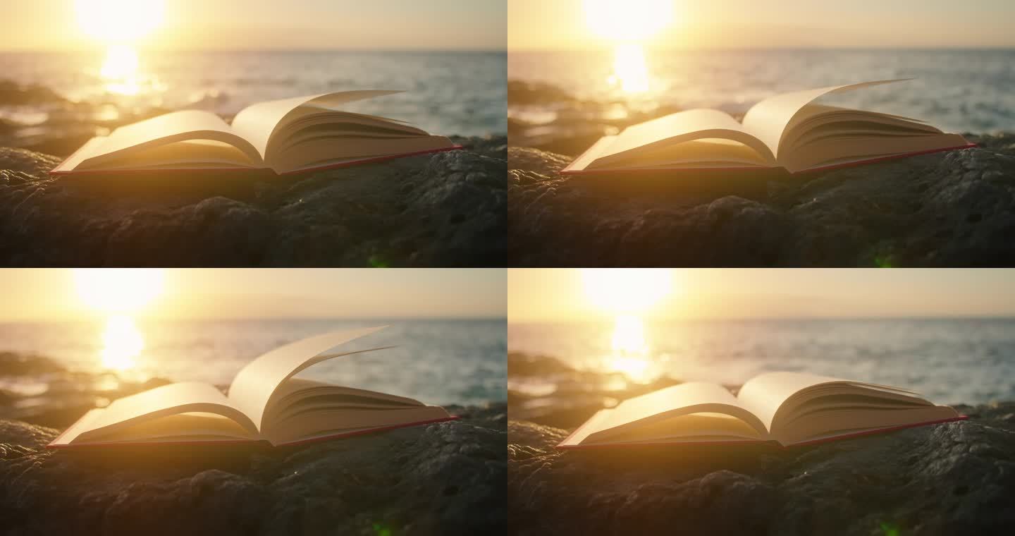日落时带着光芒在海滩上翻开的书.背景上的海浪。智慧教育科学概念.