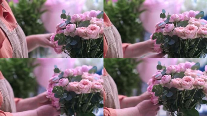 花店店员手牵手，为您创造出美丽而充满活力的粉红色玫瑰花束，花束中百花齐放