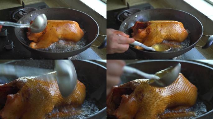 厨房里厨师在用油锅油炸一整只鸭子