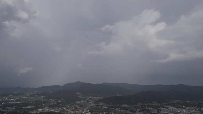 航拍雨后城市山边大彩虹