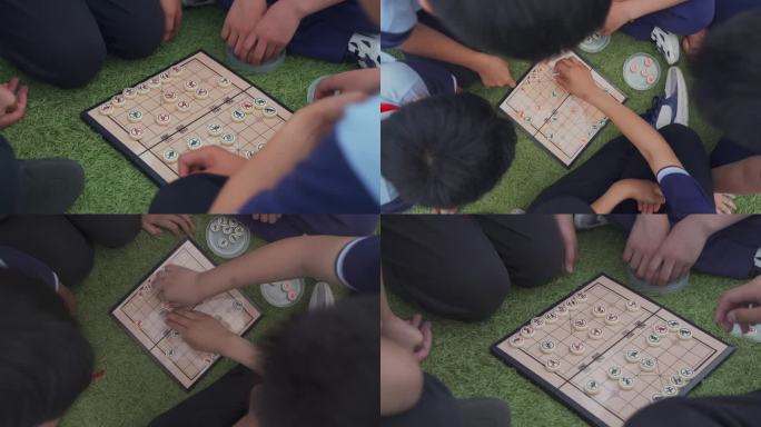 草地上的下象棋的小学生