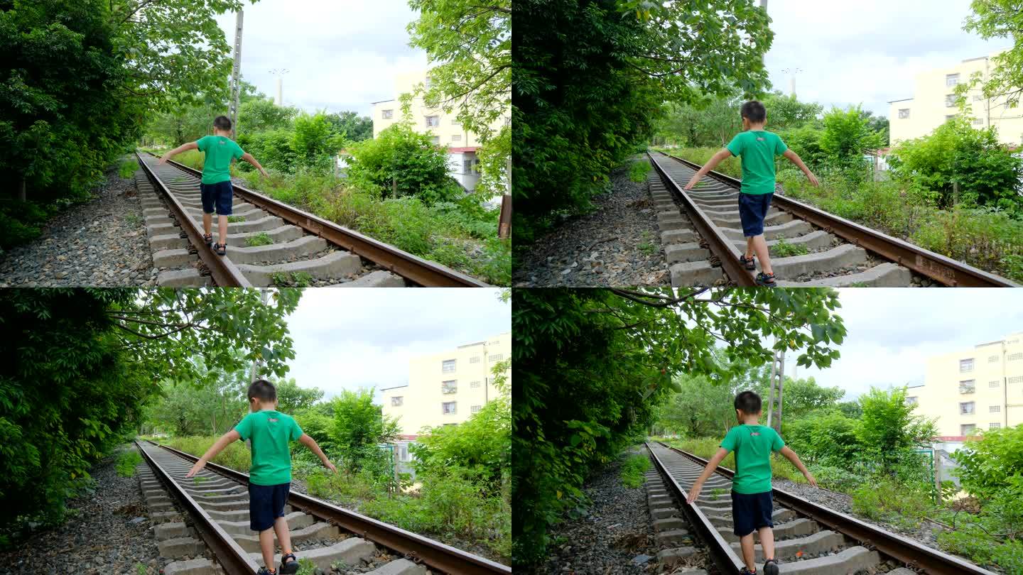 小孩走在铁路上玩耍