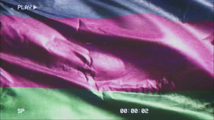 VHS录像带记录了库班人民共和国国旗迎风飘扬的情景。故障噪音与时间计数器记录横幅在微风中摇曳。无缝循