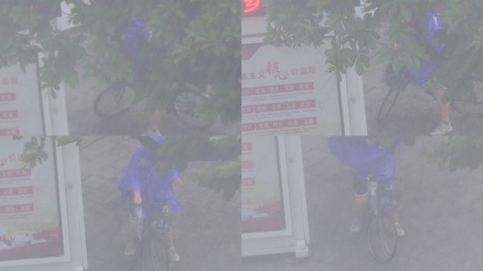 暴雨中骑车人穿雨衣
