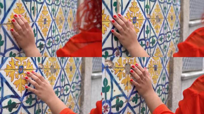 一名妇女抚摸着铺满Azulejo瓷砖的墙壁