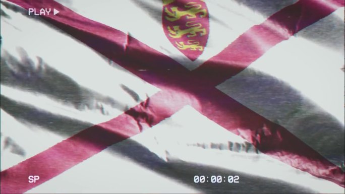 VHS录像带记录了泽西岛的国旗在风中飘扬。故障噪音与时间计数器记录杰斯基旗帜在微风中摇曳。无缝循环。