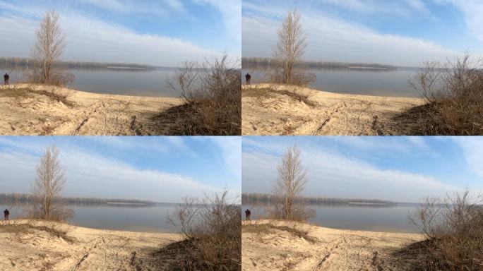 沙质公路通往乌克兰的第聂伯河，在春天的早晨步行到河边