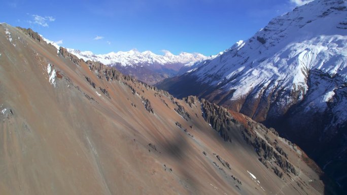 上升鸟瞰图喜马拉雅山脉与雪峰在阳光明媚的夏日。雄伟壮丽的尼泊尔风景在路线上提利科大本营。安纳普尔纳环