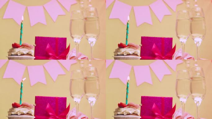女孩的出生日期。蛋糕和燃烧的蜡烛。用香槟祝贺。粉红色的蝴蝶结和礼盒。周年纪念日。给女人的视频明信片