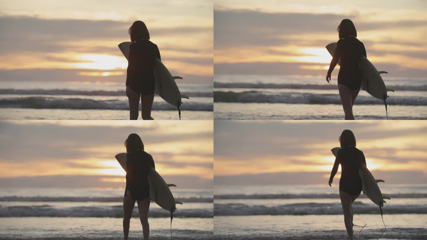 夕阳下的热带海滩上，冲浪女孩手持冲浪板的剪影。