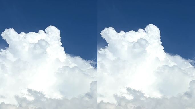 蓝蓝的天空和大片的白云是从高山上拍摄的，看起来好像是从侧面看的